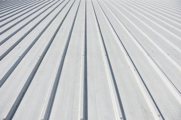 Close-up of a white metal corrugated roof, highlighting texture and pattern—ideal for showcasing quality Commercial Roofing Services.