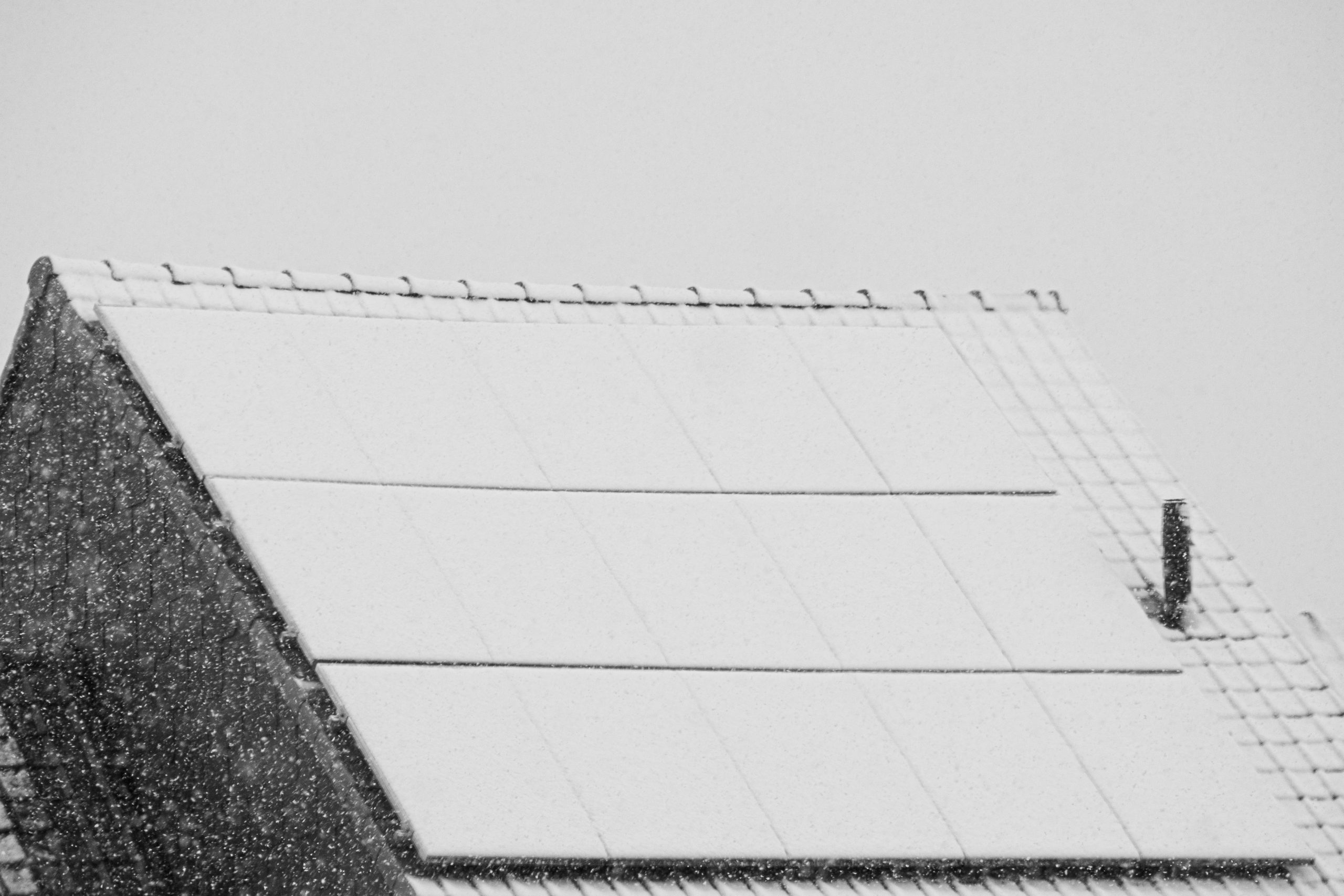 Roof with solar panels covered in snow
