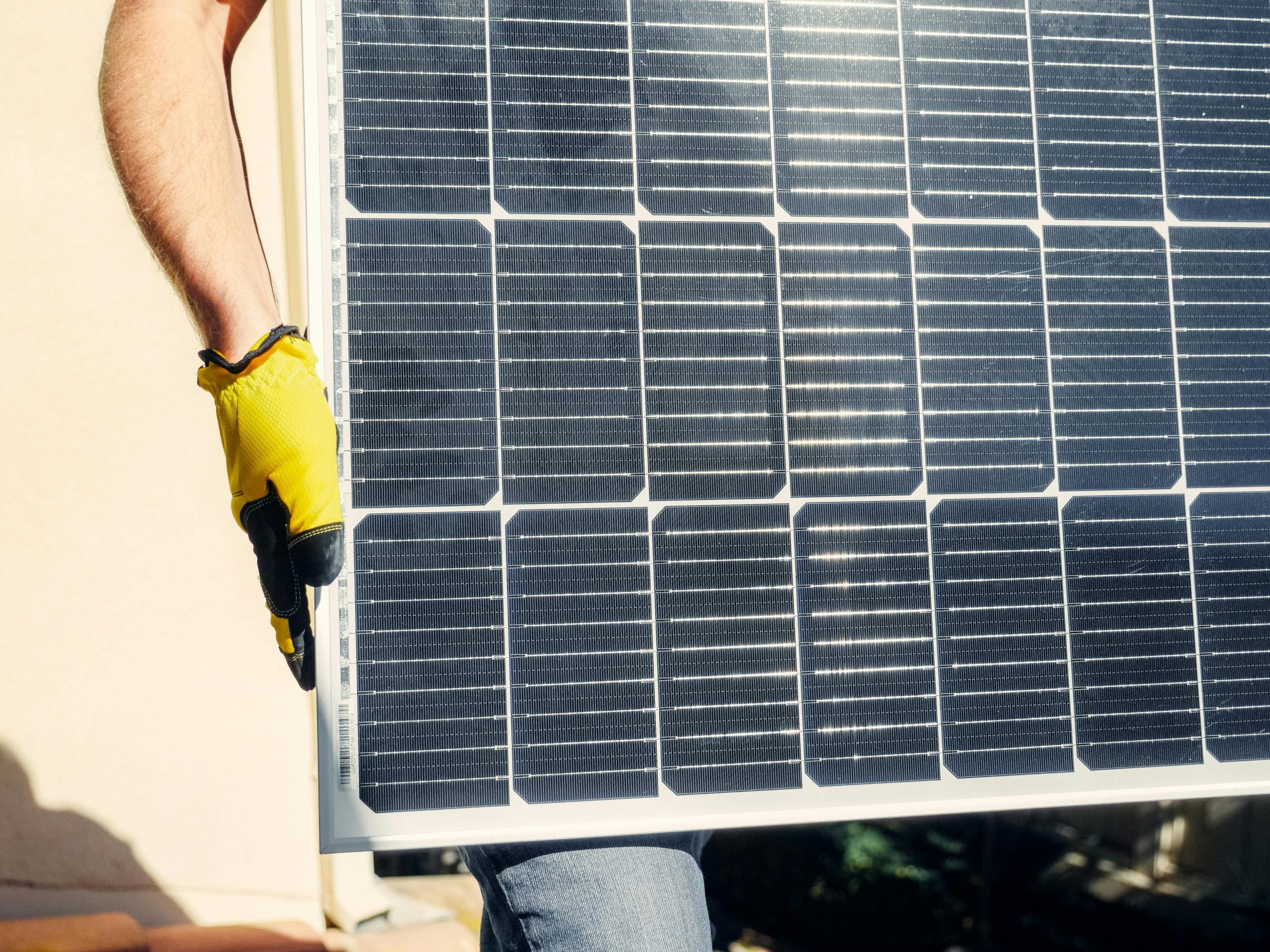 Person holding a solar panel