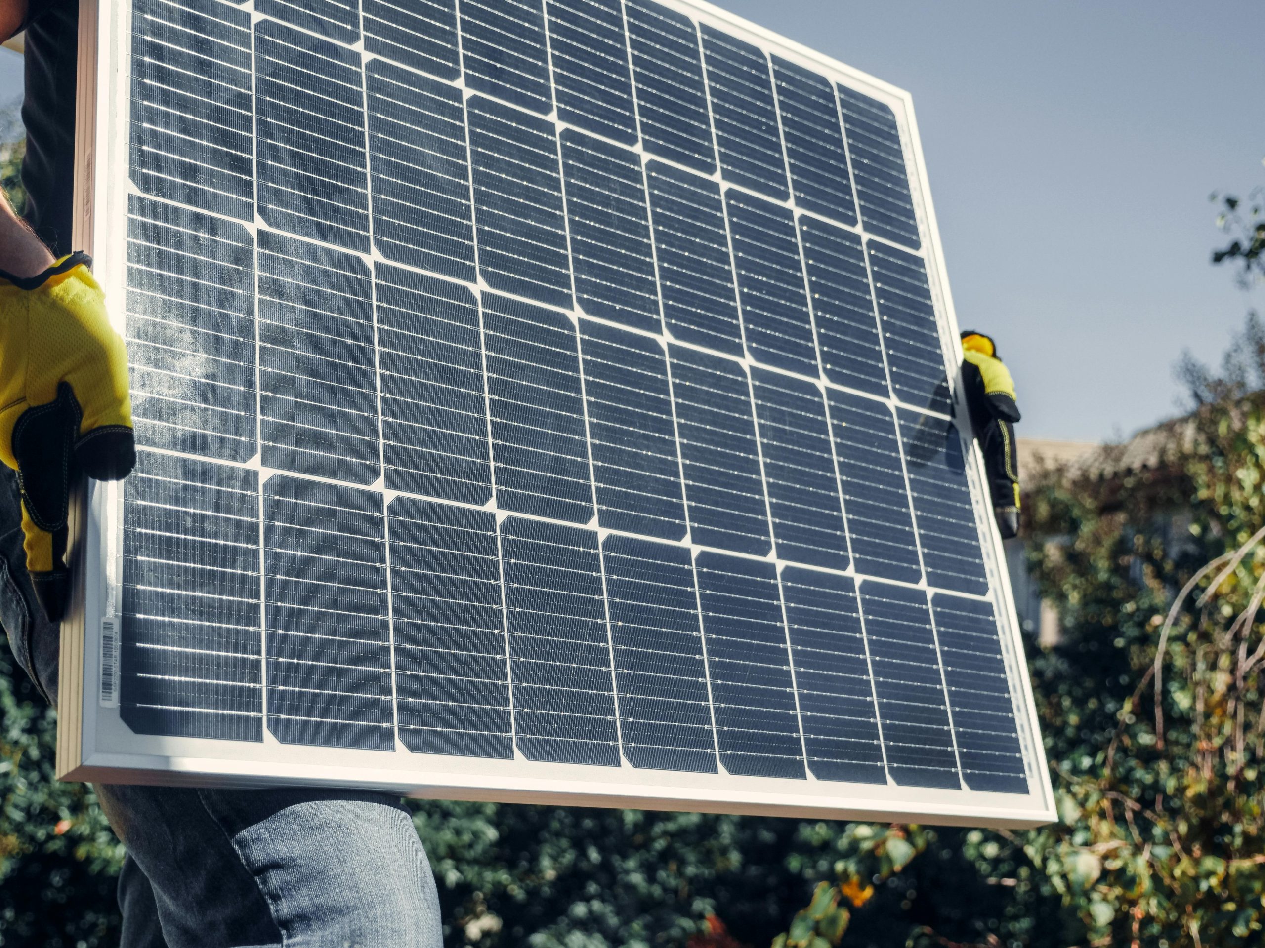 Person holding a solar panel